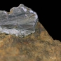 Colour image of brown rock with top tip of gray rock with high sheen