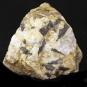 Colour image of yellow rock with black and white spots and marks